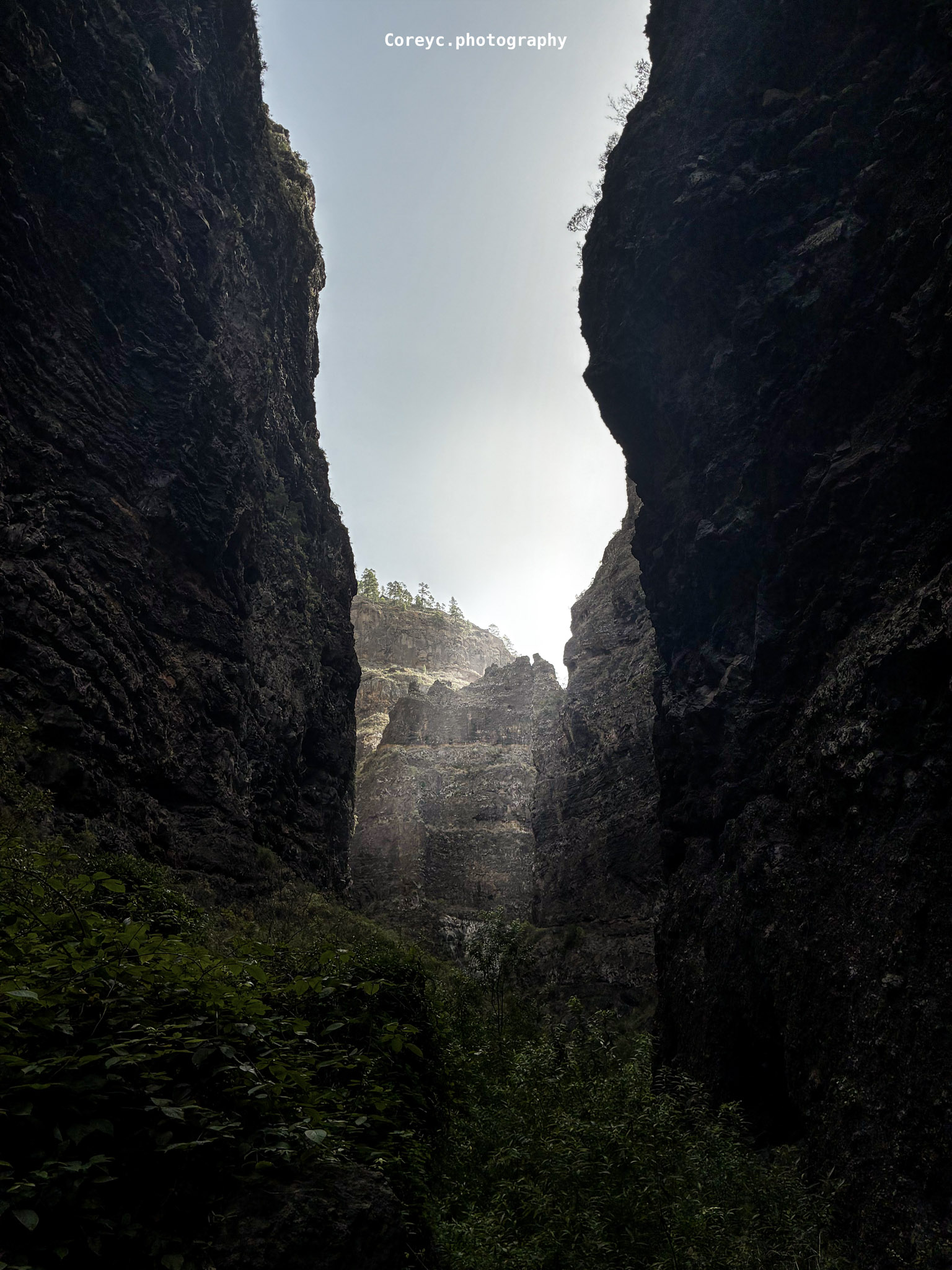Sunlight entering a steep rocky canyon