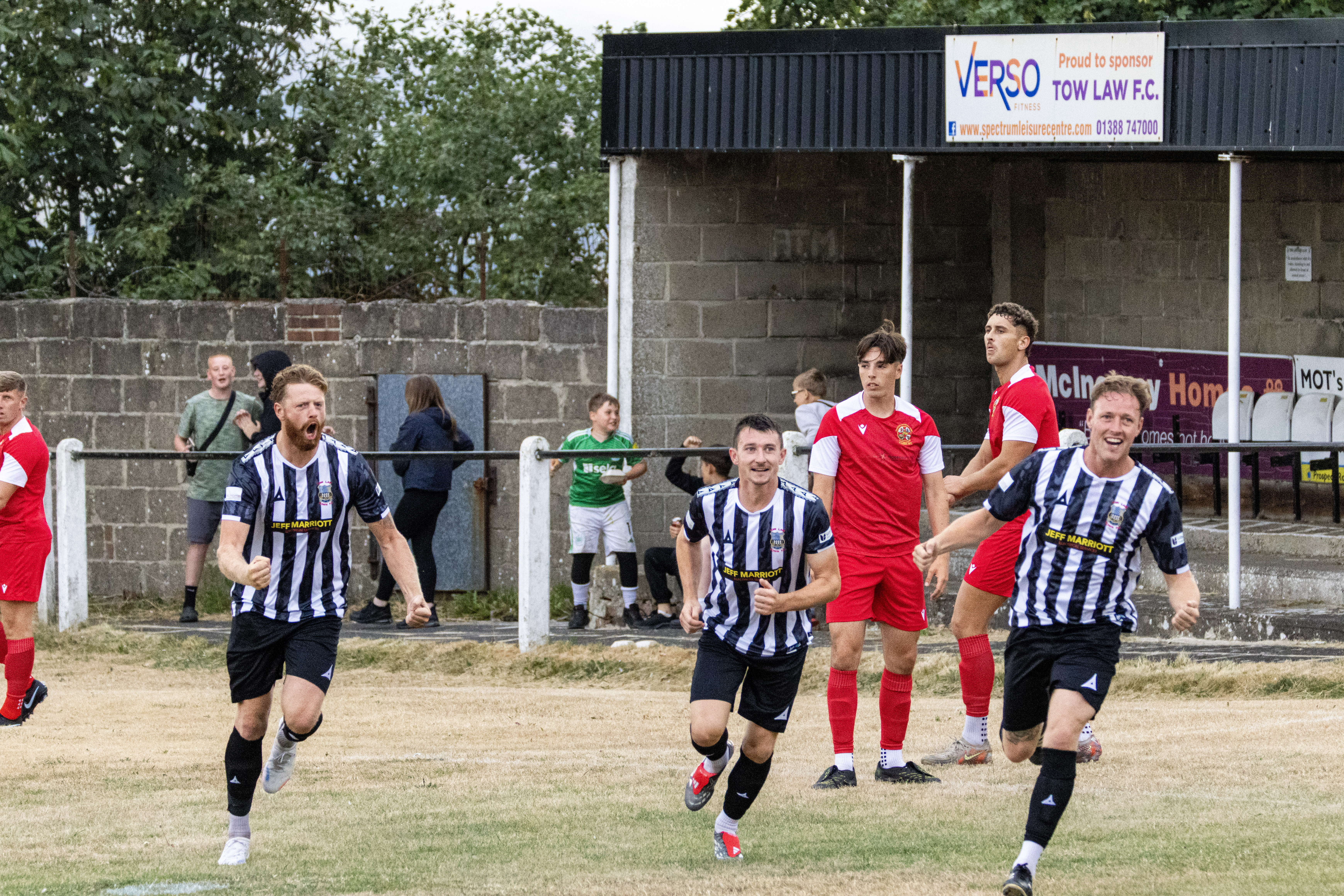 Football players celebrating after a goal