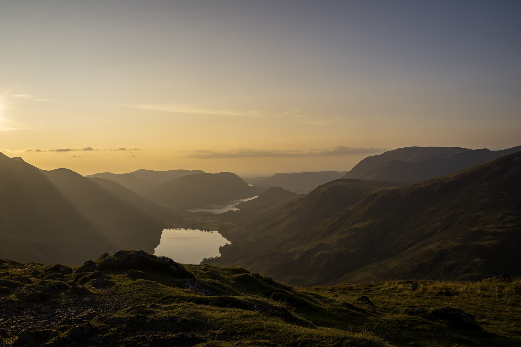 Mountain lake viewed from a sunlit ridge