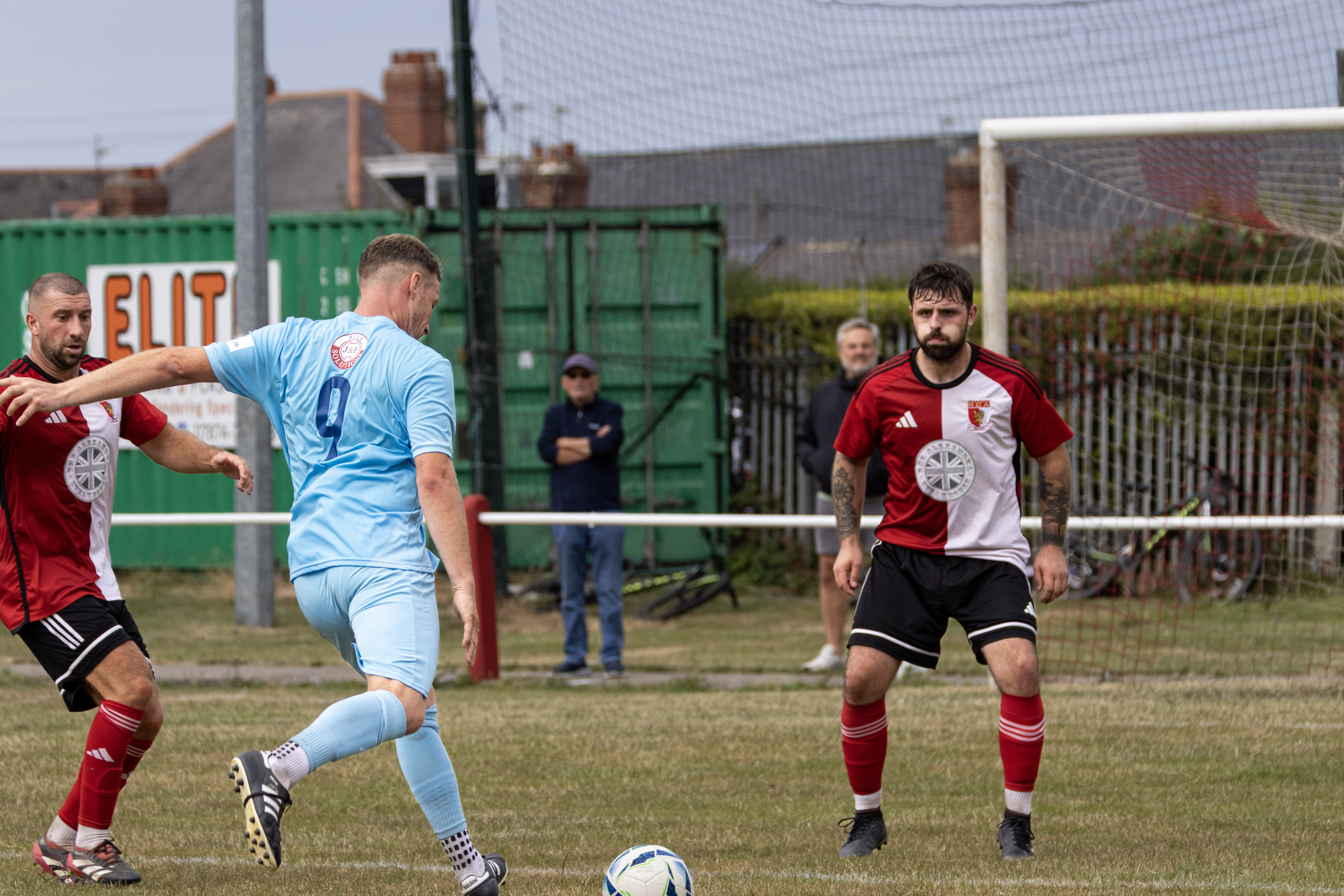Football player striking the ball during a match