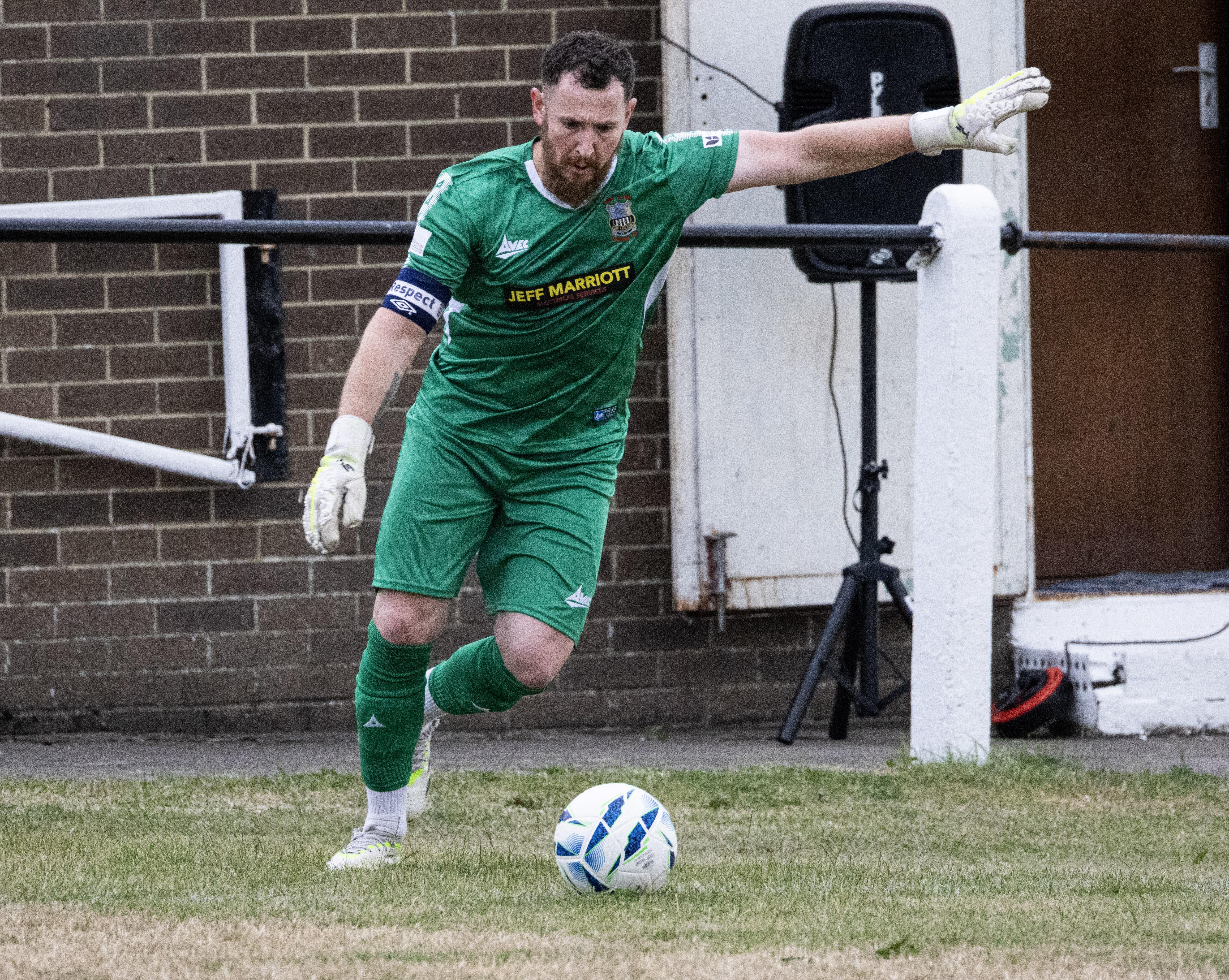 Goalkeeper kicking the ball back into play